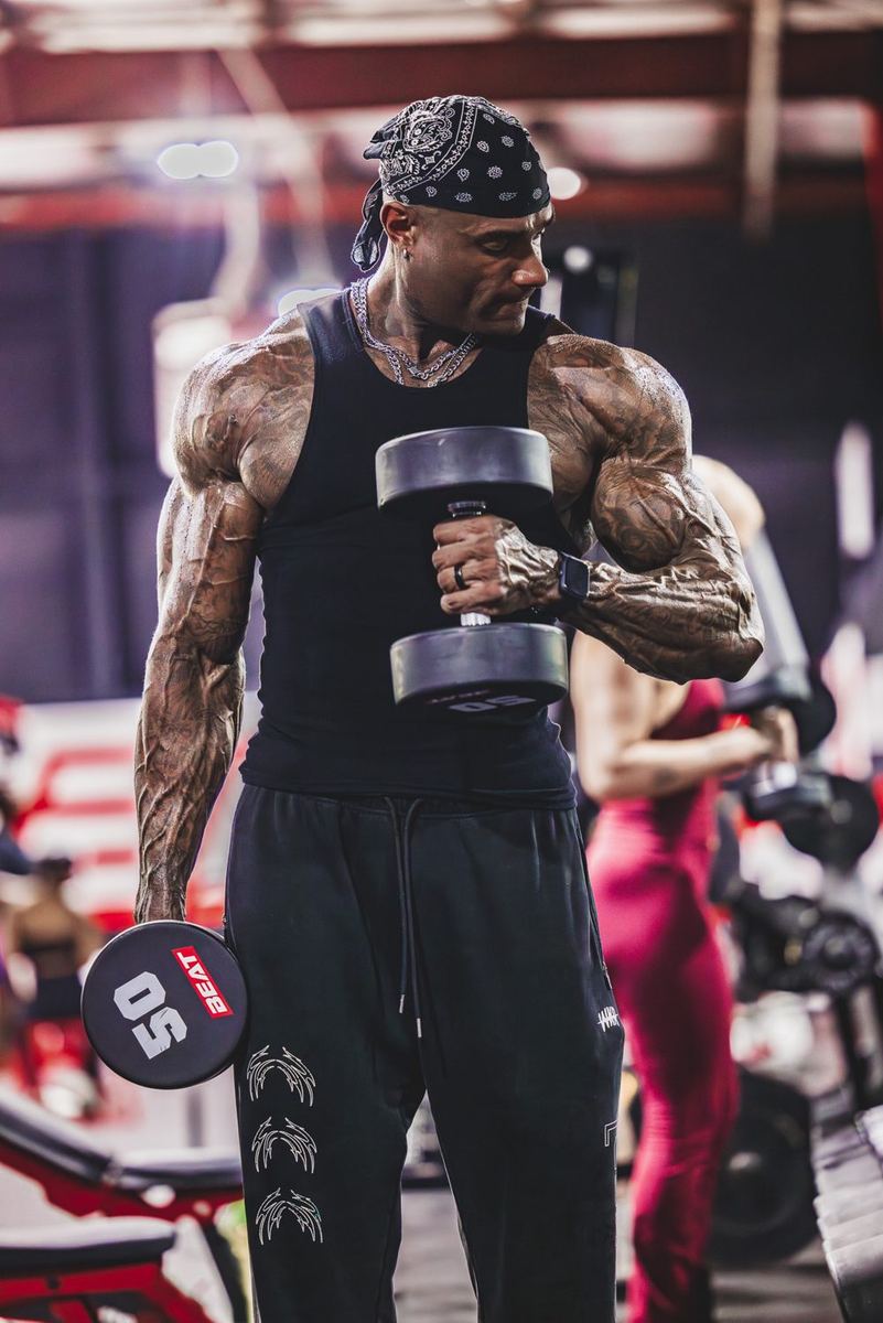 Coach Jae holding a dumbbell