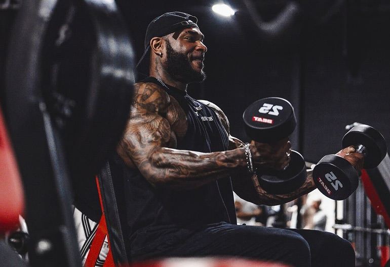 Coach Jae training with dumbbells